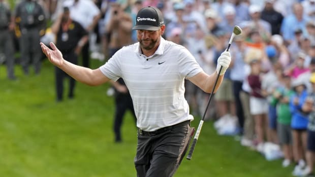 Michael Block throws his hands up while walking up the 18th green at the PGA Championship